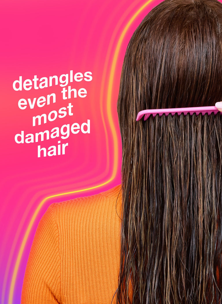 person-with-long-hair-using-a-pink-comb-against-a-pink-background-with-text-detangles-even-the-most-damaged-hair